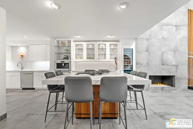 a kitchen with granite countertop white cabinets and stainless steel appliances