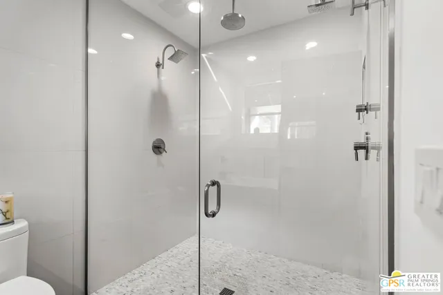 a bedroom with a large bed and a chandelier