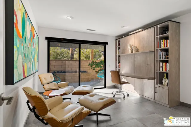 a backyard of a house with table and chairs