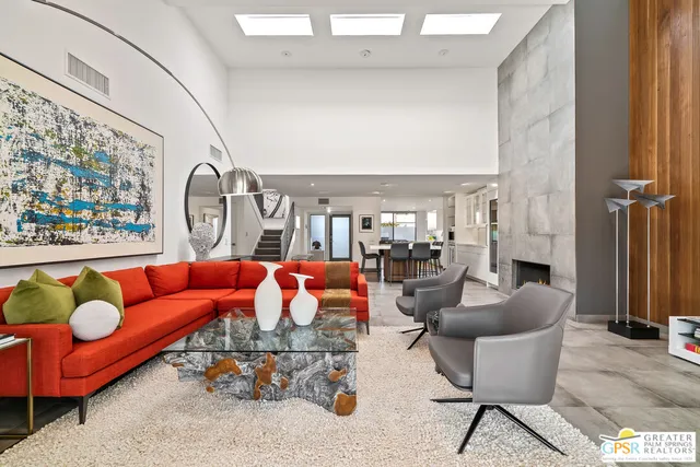 a bedroom with furniture and large windows