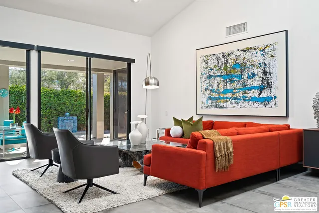 a living room with furniture a rug and a large window