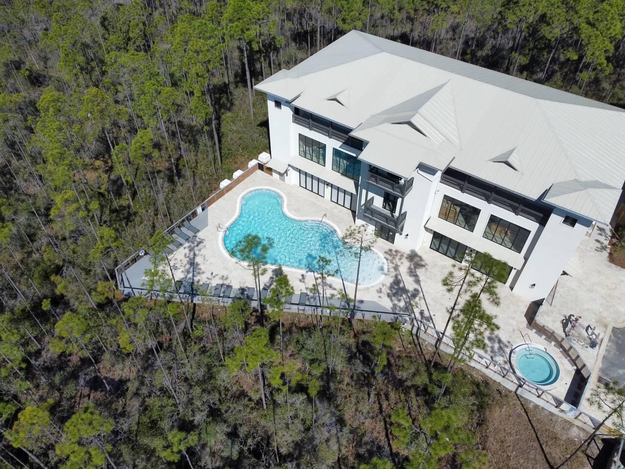 179 South County Highway 393, Unit 333 Santa Rosa Beach, FL 32459 - Photo 17 of 34 an aerial view of a house with a yard and trees