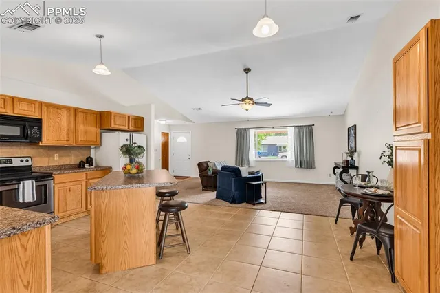 a view of a dining room with furniture and window