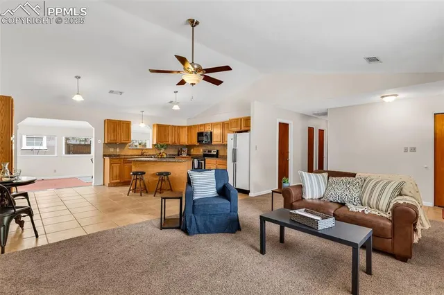a living room with furniture and kitchen view