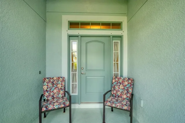 a living room with furniture kitchen and a chandelier