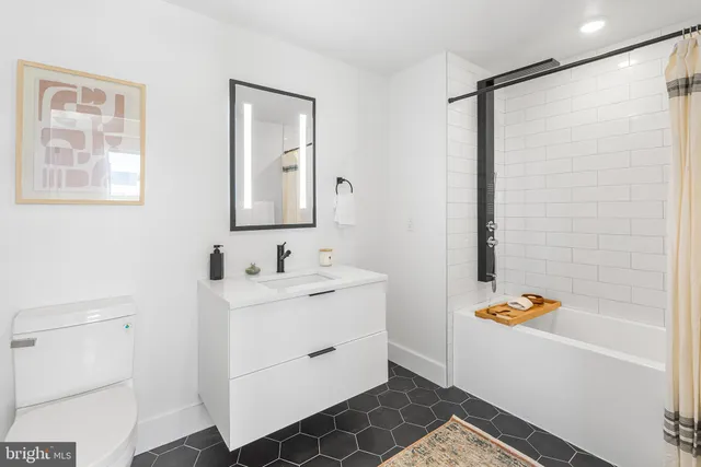 a bathroom with a tub sink and mirror
