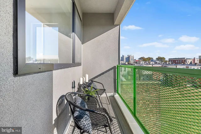 a balcony with table and chairs