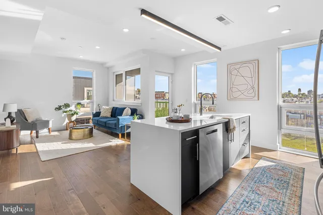 a living room with furniture and a dining table