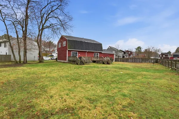 a house view with swimming pool in front of it