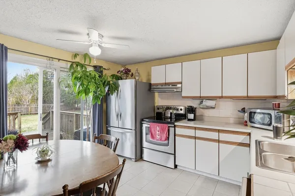 a kitchen with stainless steel appliances granite countertop a stove refrigerator sink and cabinets