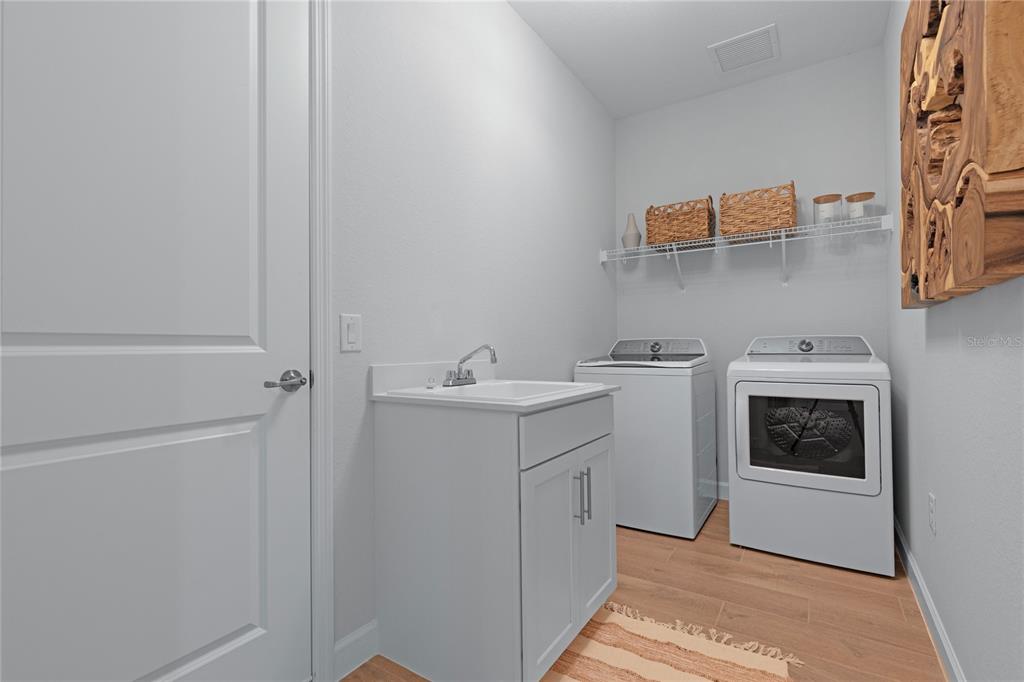 7157 Inlet Isles Lakewood Ranch, FL 34202 - Photo 26 of 26 a utility room with sink dryer and washer