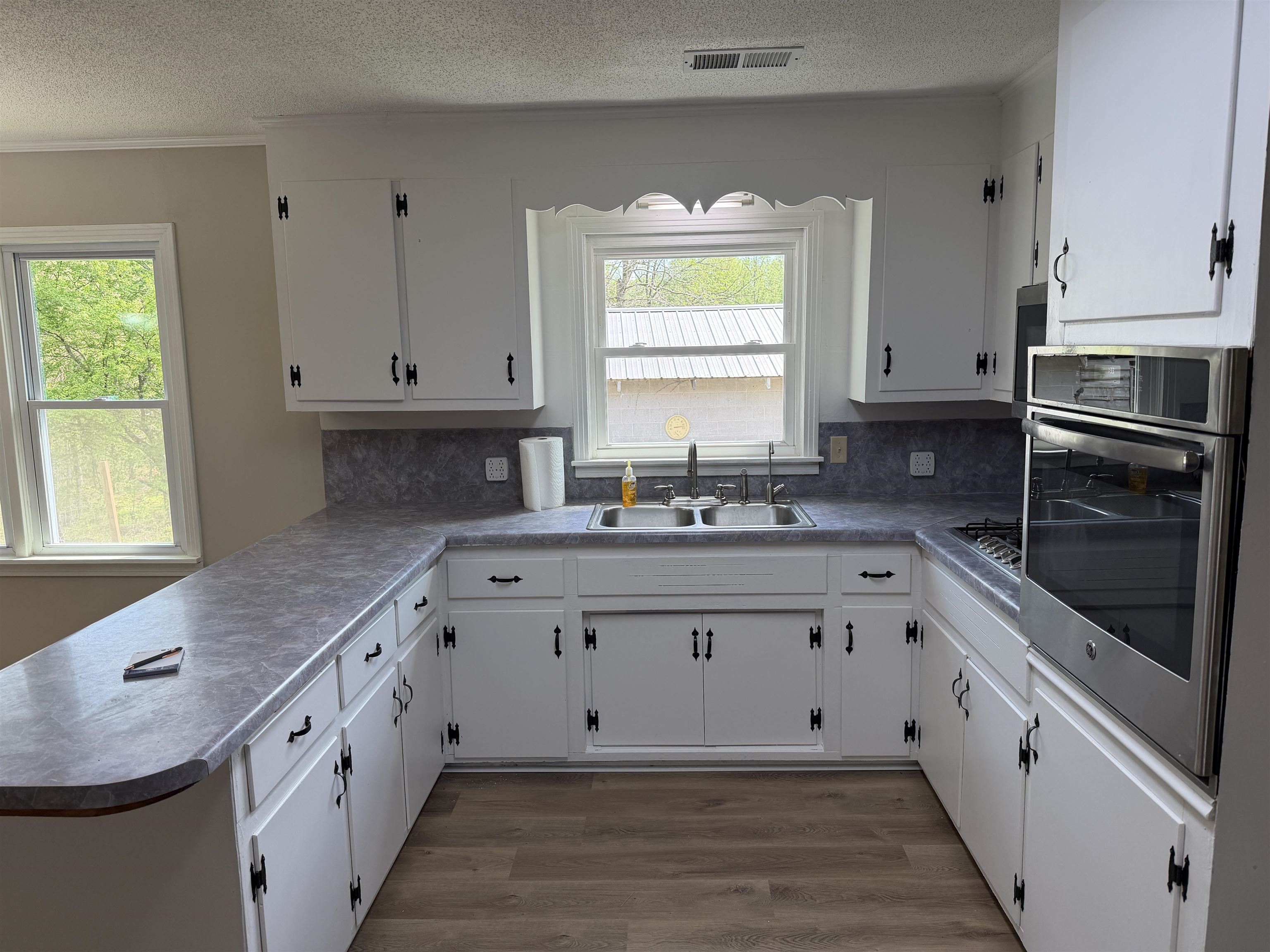940 Old Lula Road Reagan, TN 38368 - Photo 11 of 39 a kitchen with granite countertop white cabinets white stainless steel appliances a sink and a window