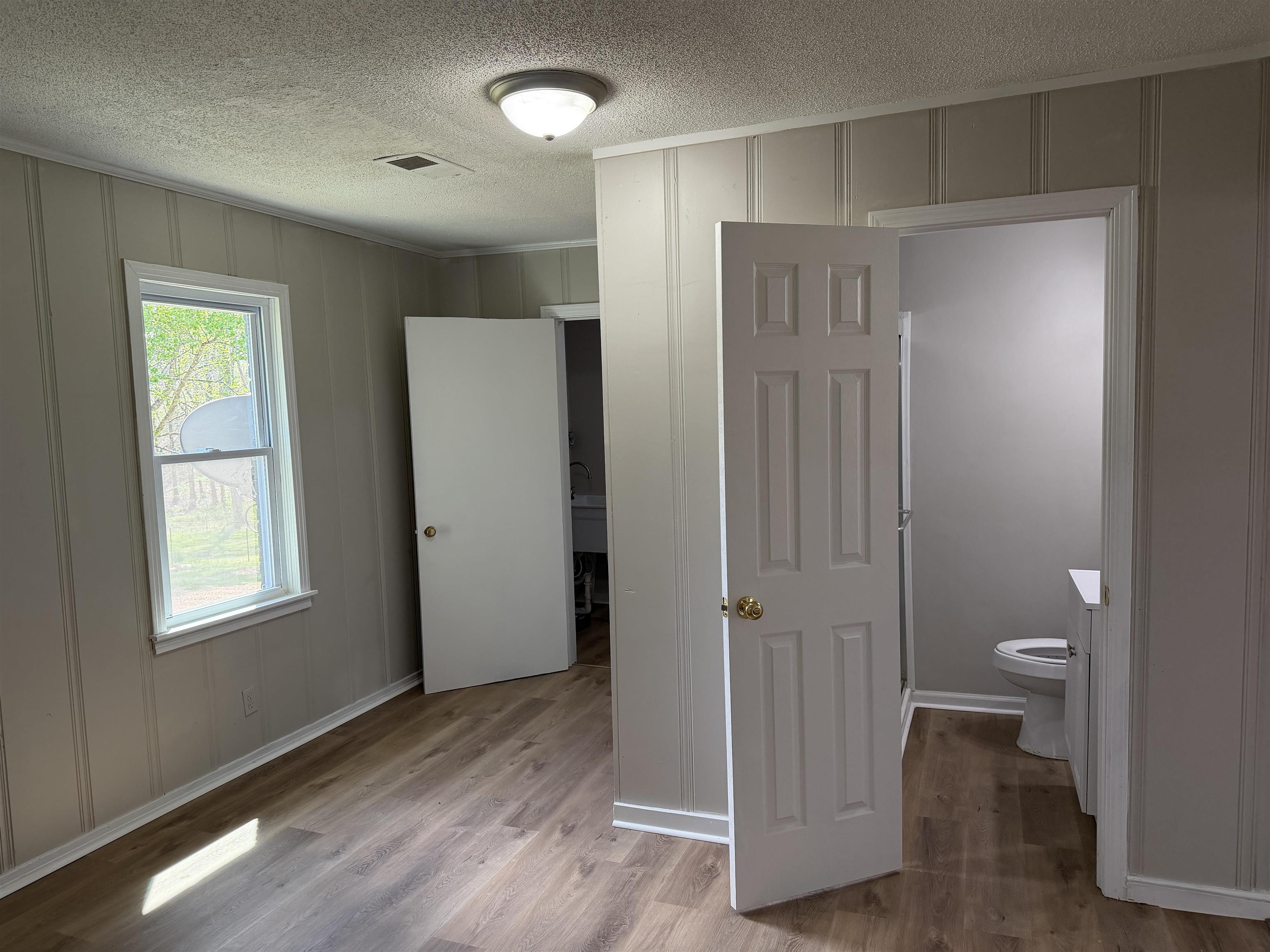 940 Old Lula Road Reagan, TN 38368 - Photo 14 of 39 a view of a bathroom with wooden floor and a toilet