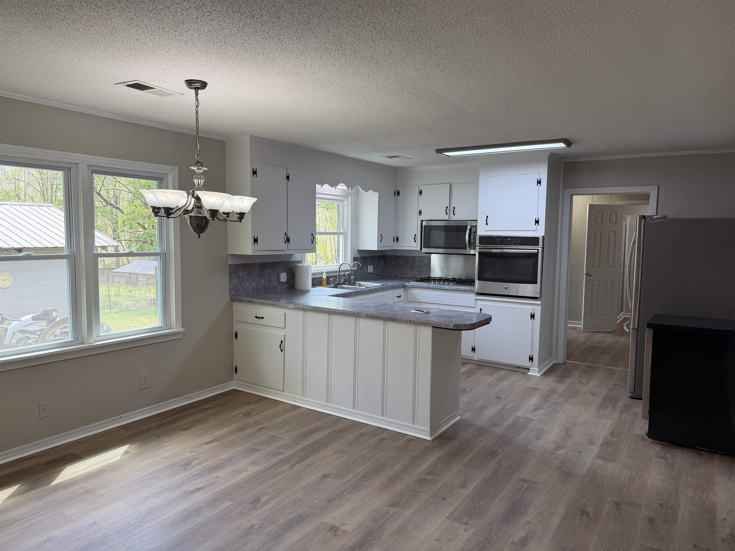 940 Old Lula Road Reagan, TN 38368 - Photo 10 of 39 a kitchen with granite countertop a refrigerator stove top oven and sink