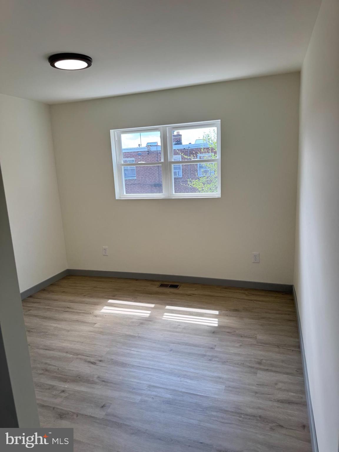 7816 Temple Road Philadelphia, PA 19150 - Photo 11 of 24 a view of an empty room with wooden floor and a window