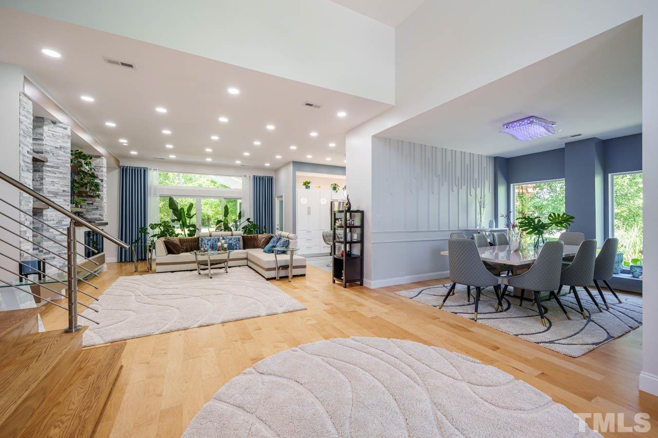 1028 Todd Road Knightdale, NC 27545 - Photo 14 of 48 a living room with furniture a dining table and a potted plant