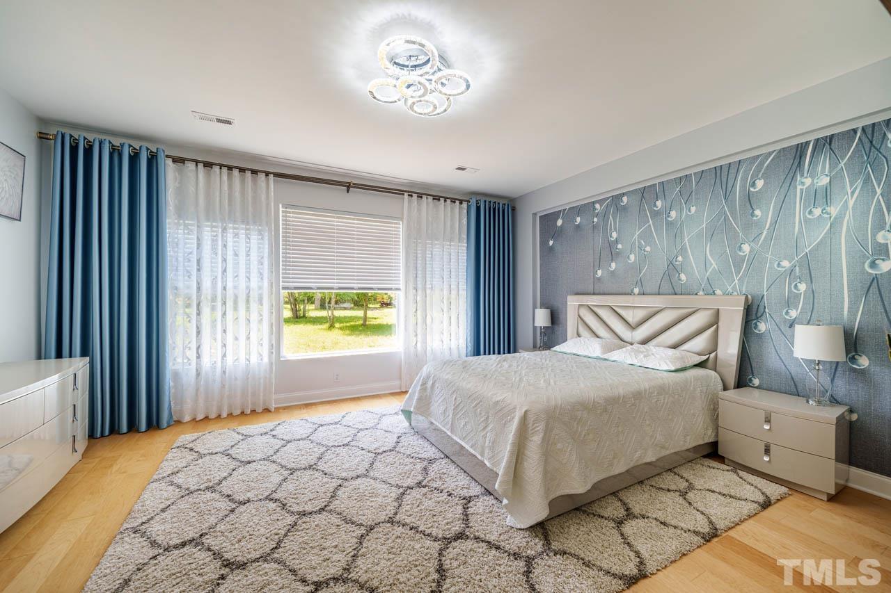 1028 Todd Road Knightdale, NC 27545 - Photo 25 of 48 a bedroom with a large bed and a window