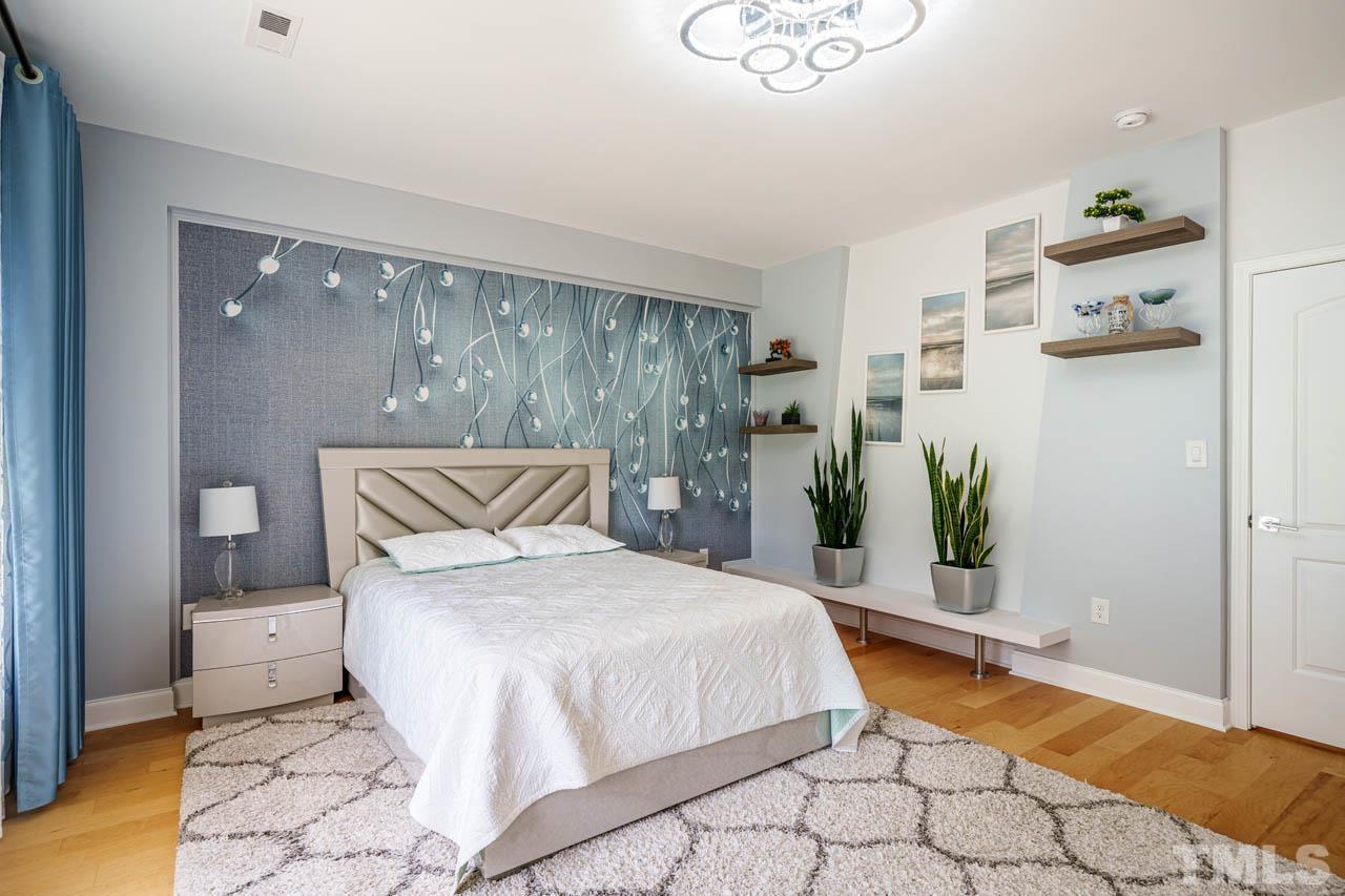 1028 Todd Road Knightdale, NC 27545 - Photo 26 of 48 a bedroom with a large bed and a potted plant