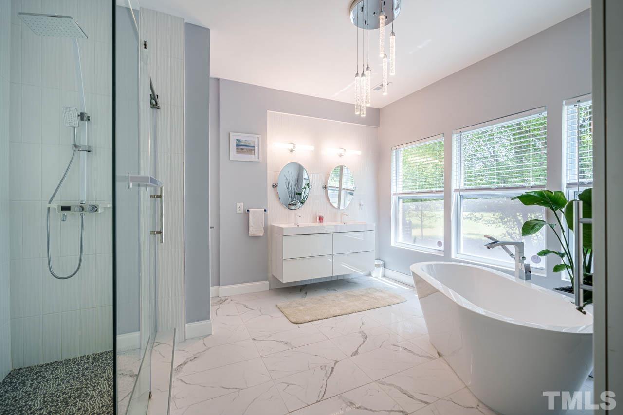 1028 Todd Road Knightdale, NC 27545 - Photo 28 of 48 a bathroom with a tub shower and sink