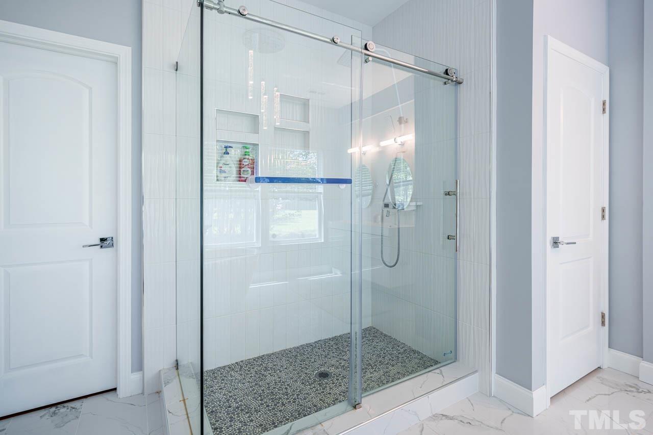 1028 Todd Road Knightdale, NC 27545 - Photo 30 of 48 a bathroom with a glass shower door