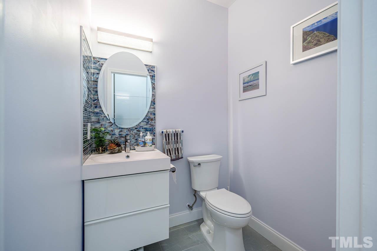 1028 Todd Road Knightdale, NC 27545 - Photo 31 of 48 a bathroom with a toilet sink and mirror