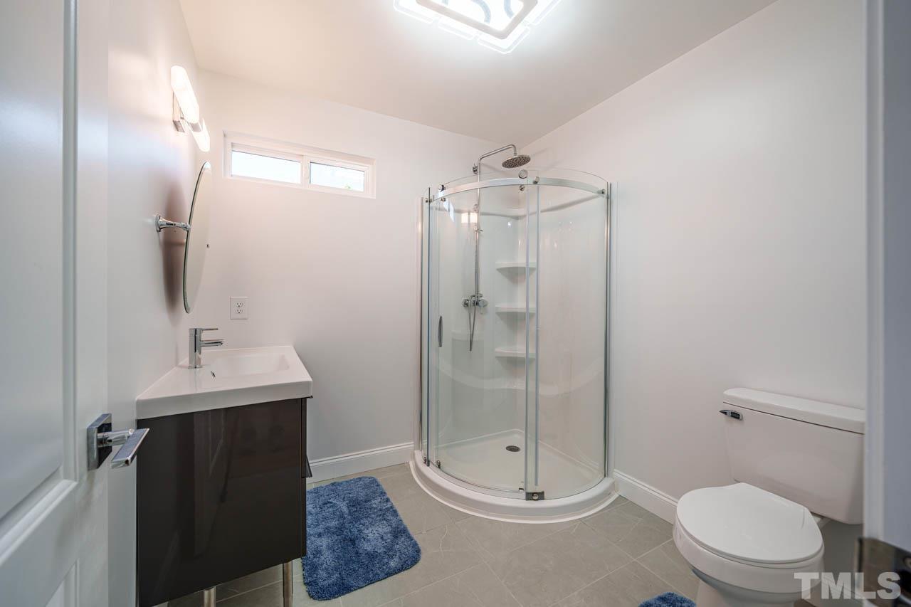 1028 Todd Road Knightdale, NC 27545 - Photo 35 of 48 a bathroom with a toilet a sink and shower