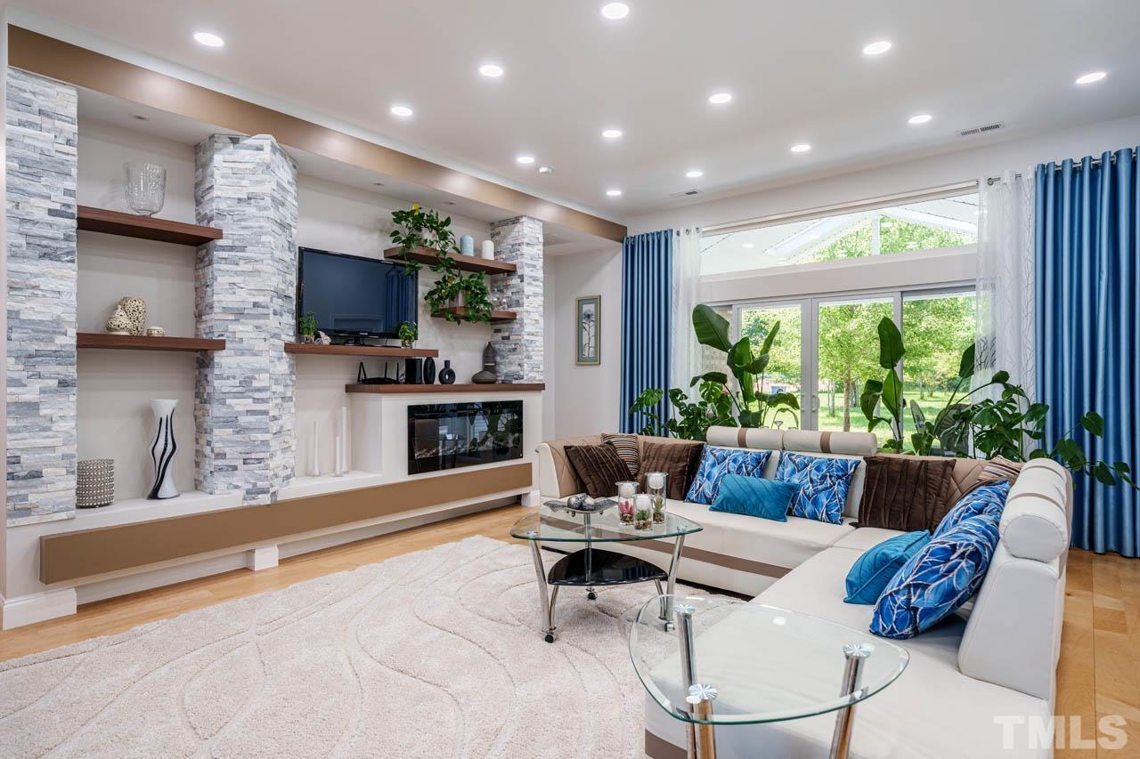 1028 Todd Road Knightdale, NC 27545 - Photo 39 of 48 a living room with fireplace furniture and a flat screen tv