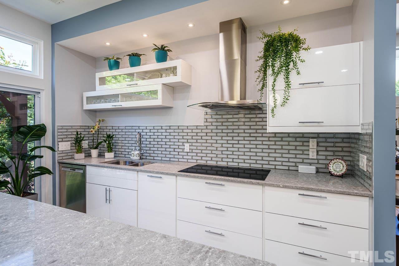 1028 Todd Road Knightdale, NC 27545 - Photo 43 of 48 a kitchen with a white cabinets and potted plant