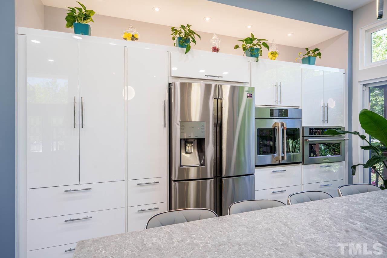 1028 Todd Road Knightdale, NC 27545 - Photo 44 of 48 a kitchen with stainless steel appliances a refrigerator and a white cabinets
