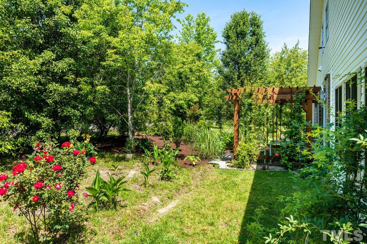 1028 Todd Road Knightdale, NC 27545 - Photo 46 of 48 a view of a flower garden in a backyard