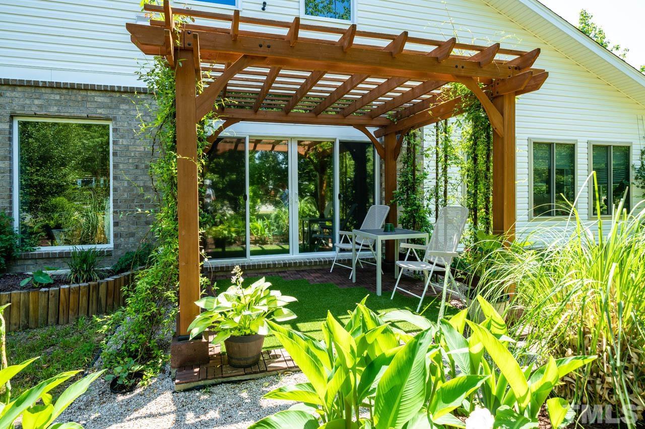 1028 Todd Road Knightdale, NC 27545 - Photo 10 of 48 a patio with yard glass top table and chairs