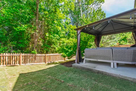 a view of backyard with green space and deck