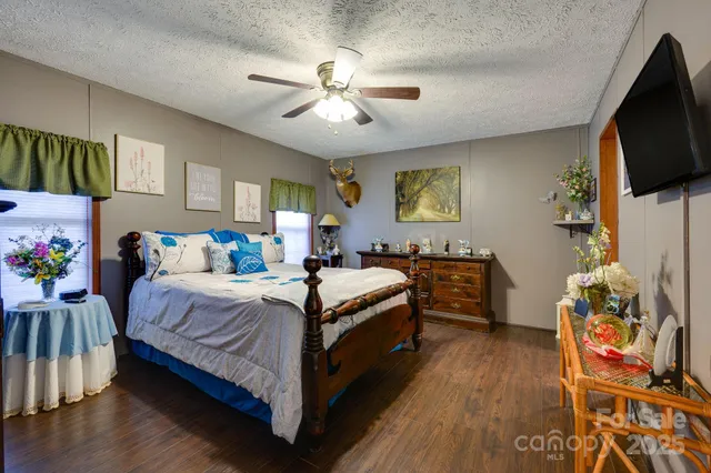 a bedroom with a bed and flat screen tv