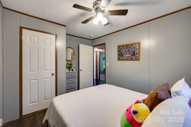 a bedroom with a bed dresser and a window