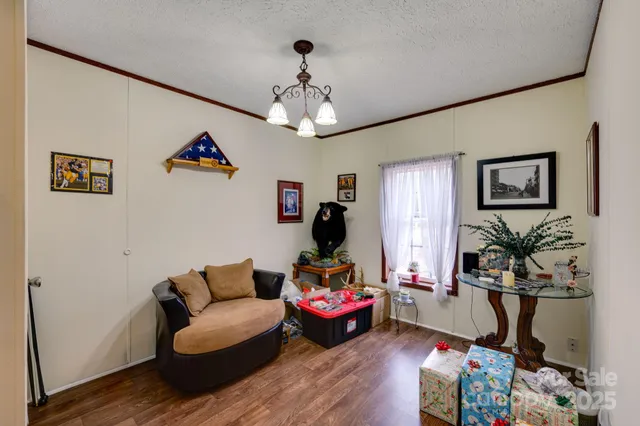 a living room with furniture and a chandelier