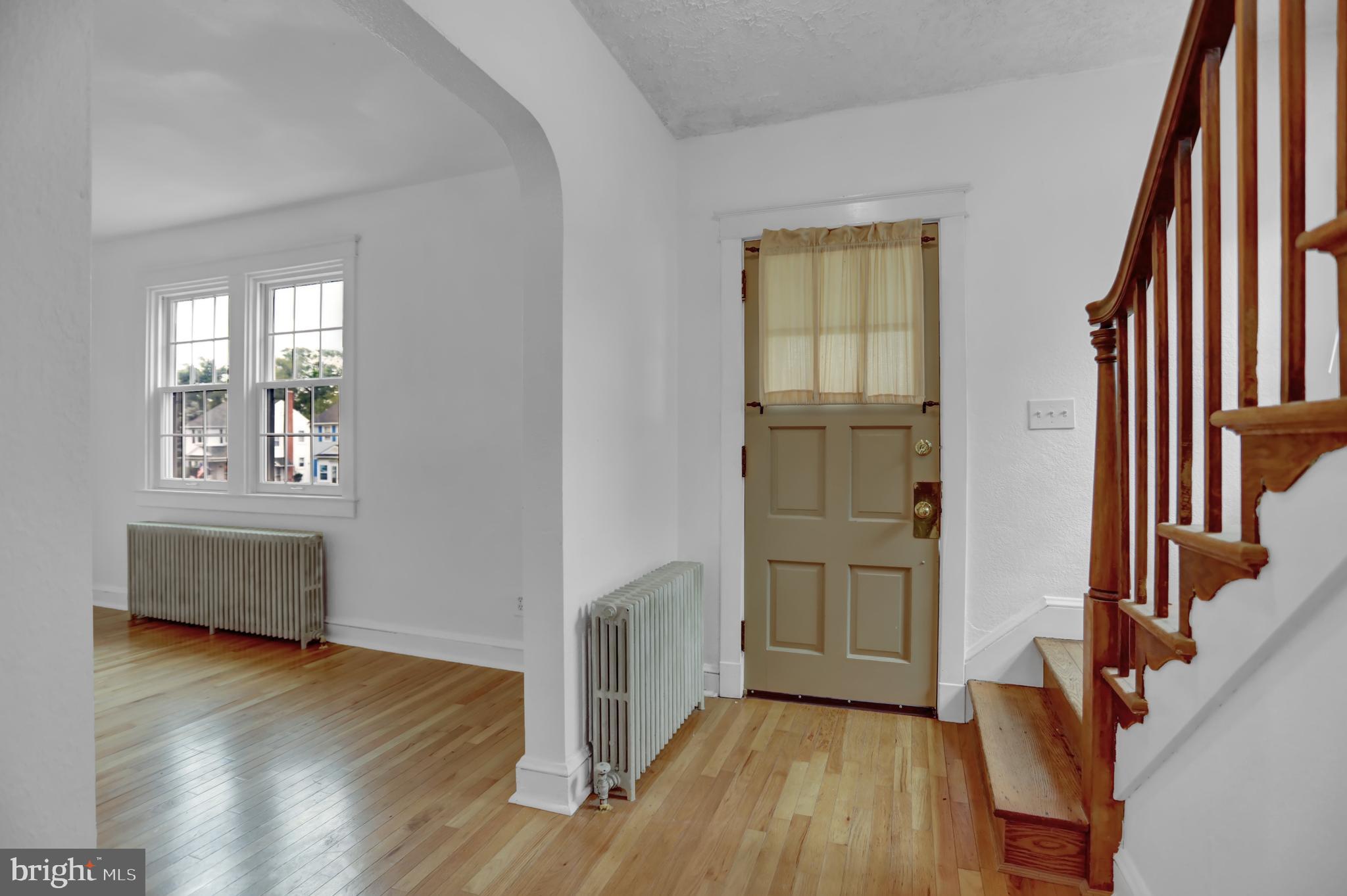 5544 Ashbourne Road Baltimore, MD 21227 - Photo 16 of 40 a view of an empty room with wooden floor and a window