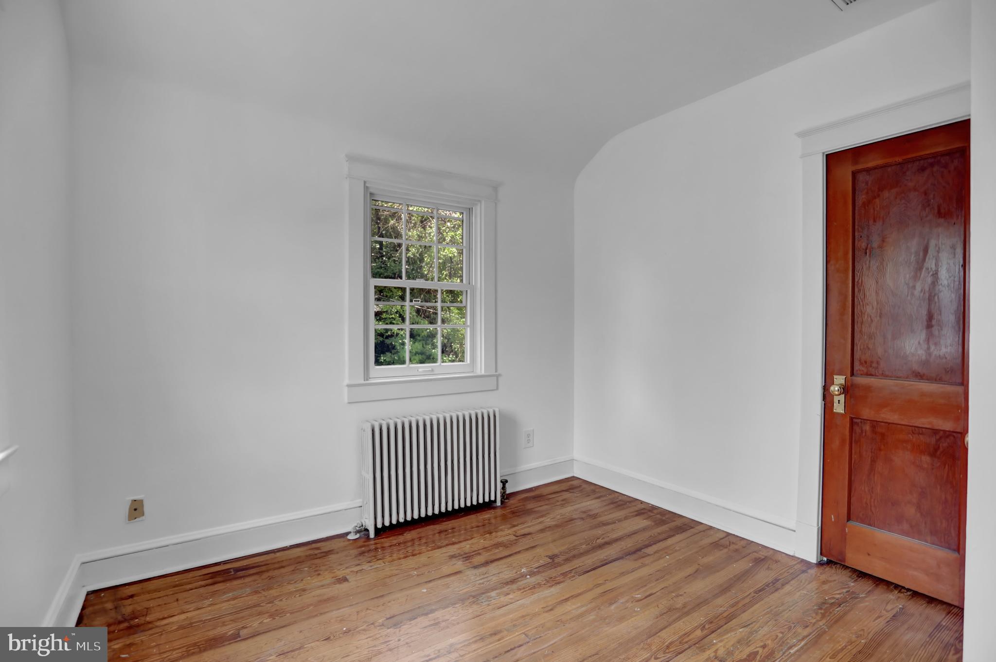 5544 Ashbourne Road Baltimore, MD 21227 - Photo 19 of 40 an empty room with wooden floor and windows