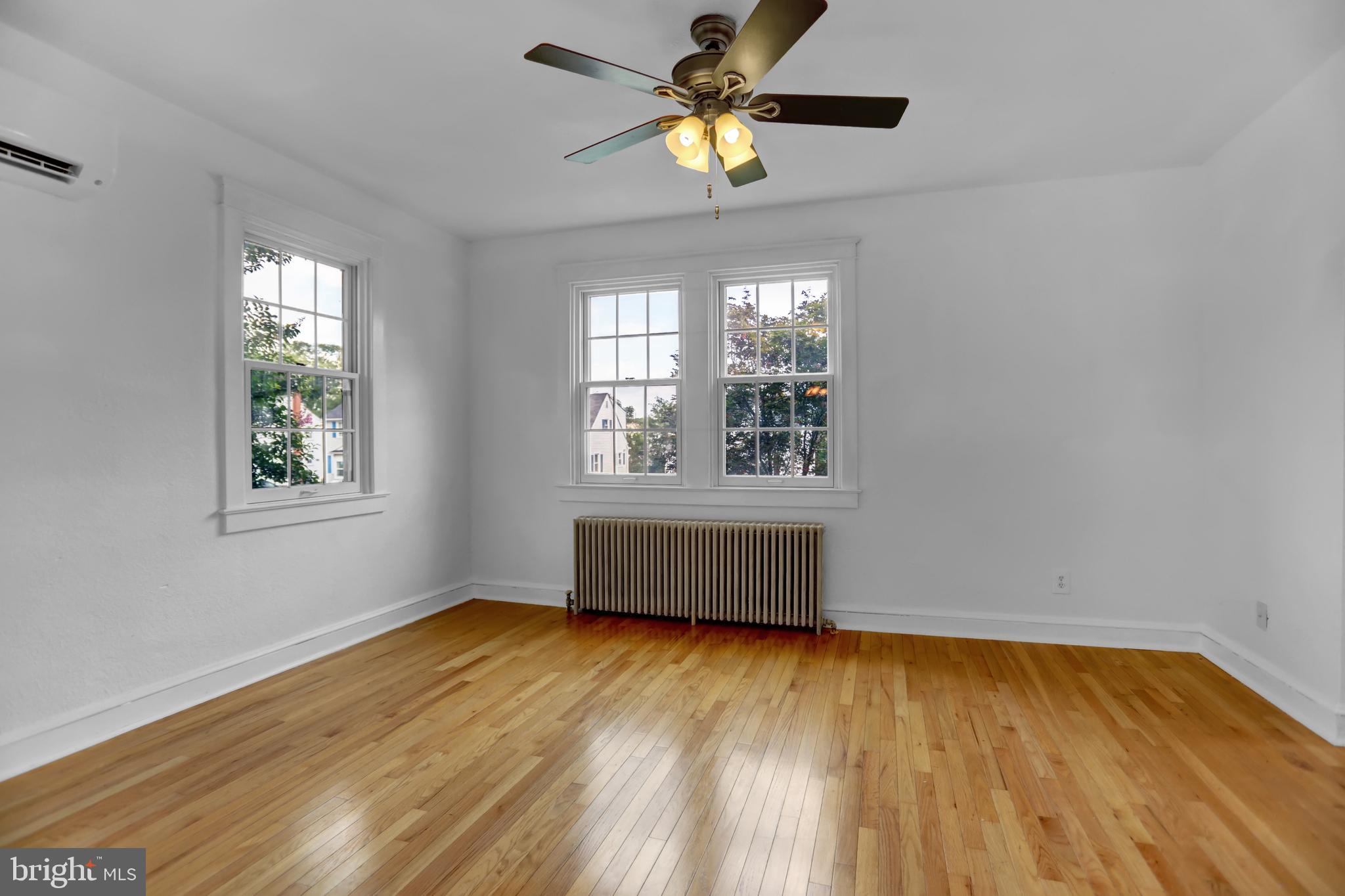 5544 Ashbourne Road Baltimore, MD 21227 - Photo 25 of 40 a view of empty room with wooden floor and fan