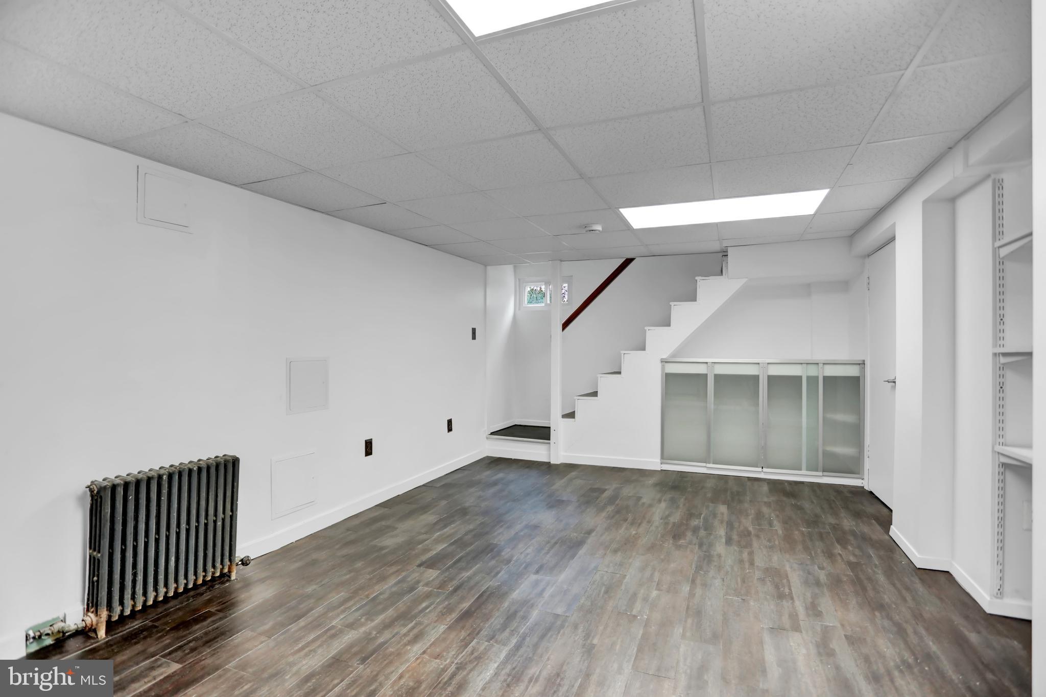 5544 Ashbourne Road Baltimore, MD 21227 - Photo 26 of 40 wooden floor in an empty room