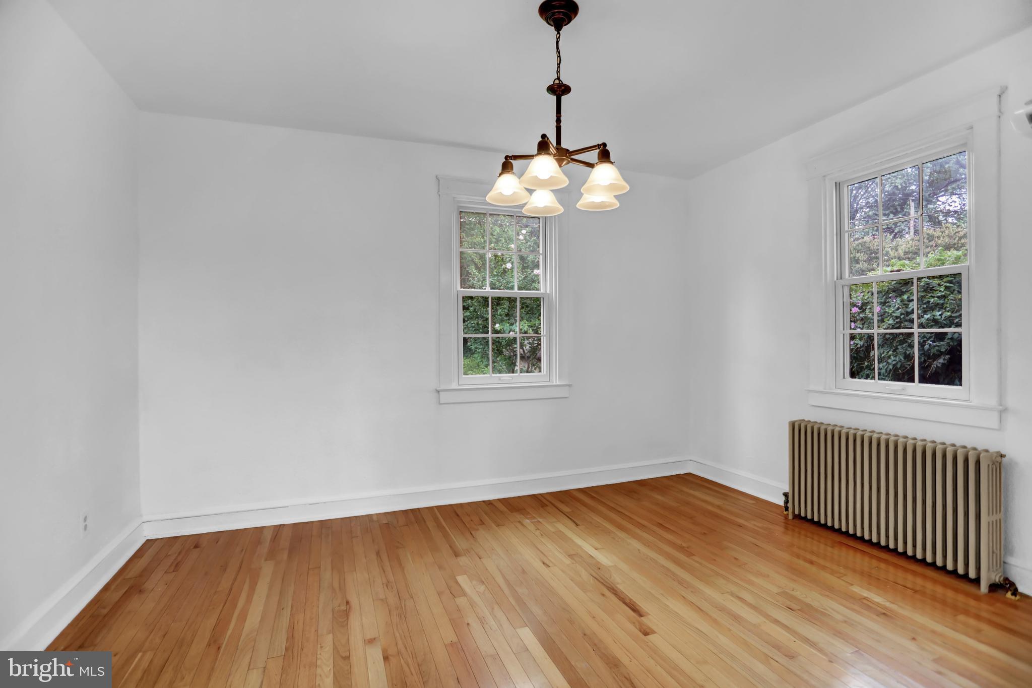 5544 Ashbourne Road Baltimore, MD 21227 - Photo 28 of 40 a view of a room with wooden floor chandelier and windows