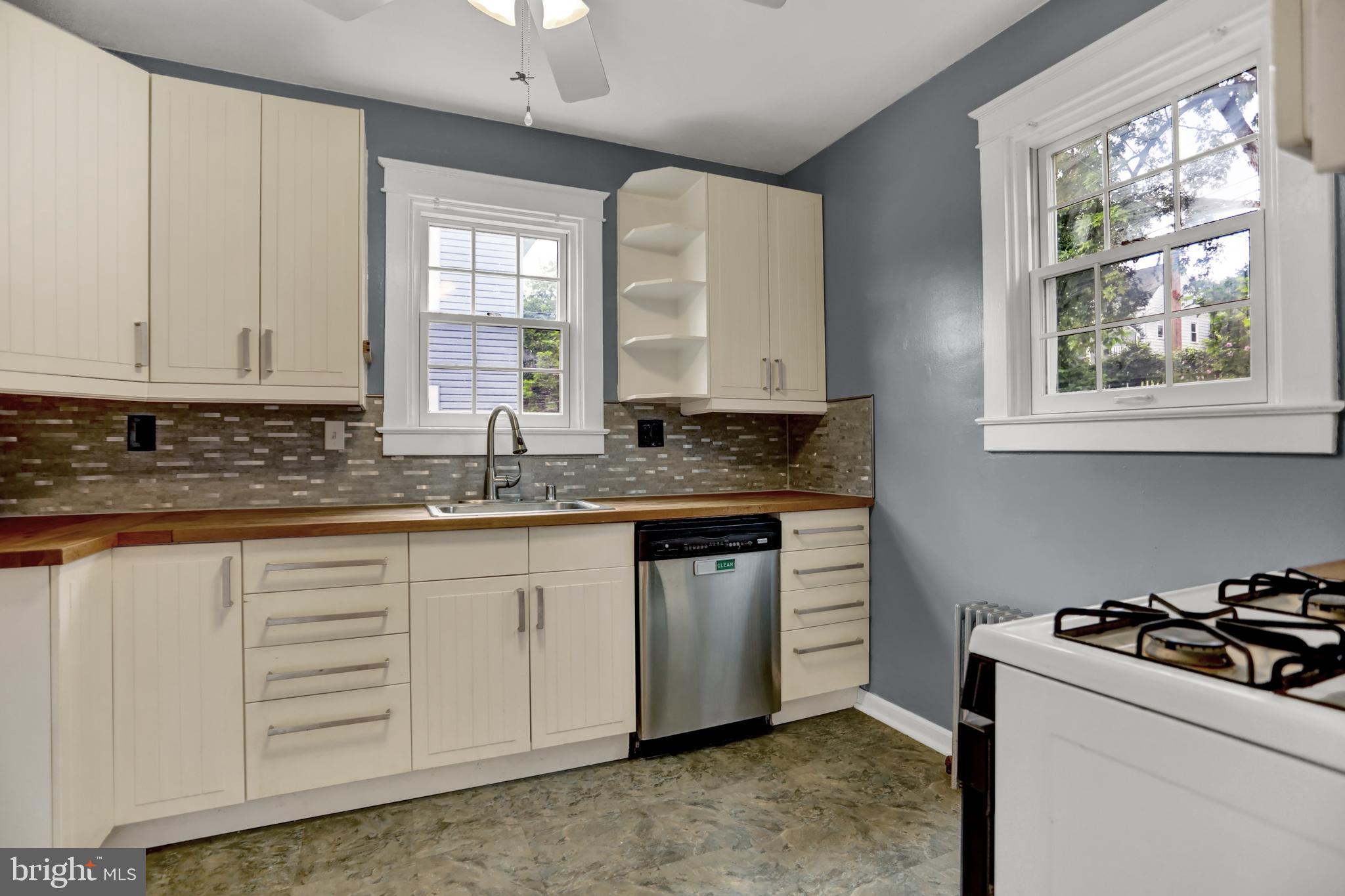 5544 Ashbourne Road Baltimore, MD 21227 - Photo 30 of 40 a kitchen with granite countertop white cabinets and window