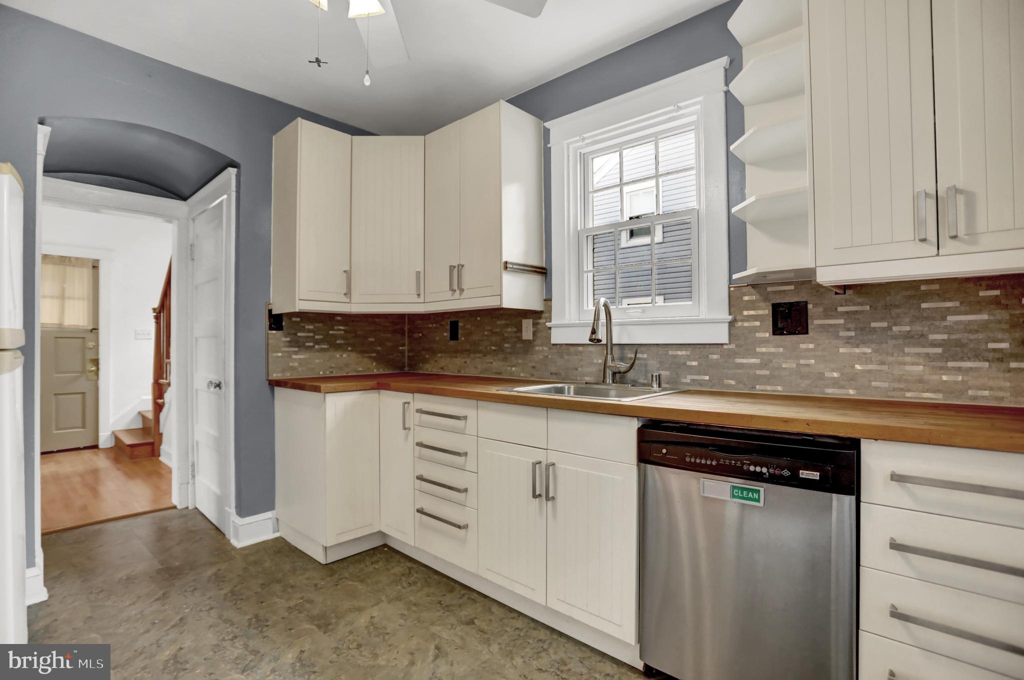 5544 Ashbourne Road Baltimore, MD 21227 - Photo 31 of 40 a kitchen with granite countertop a sink and cabinets