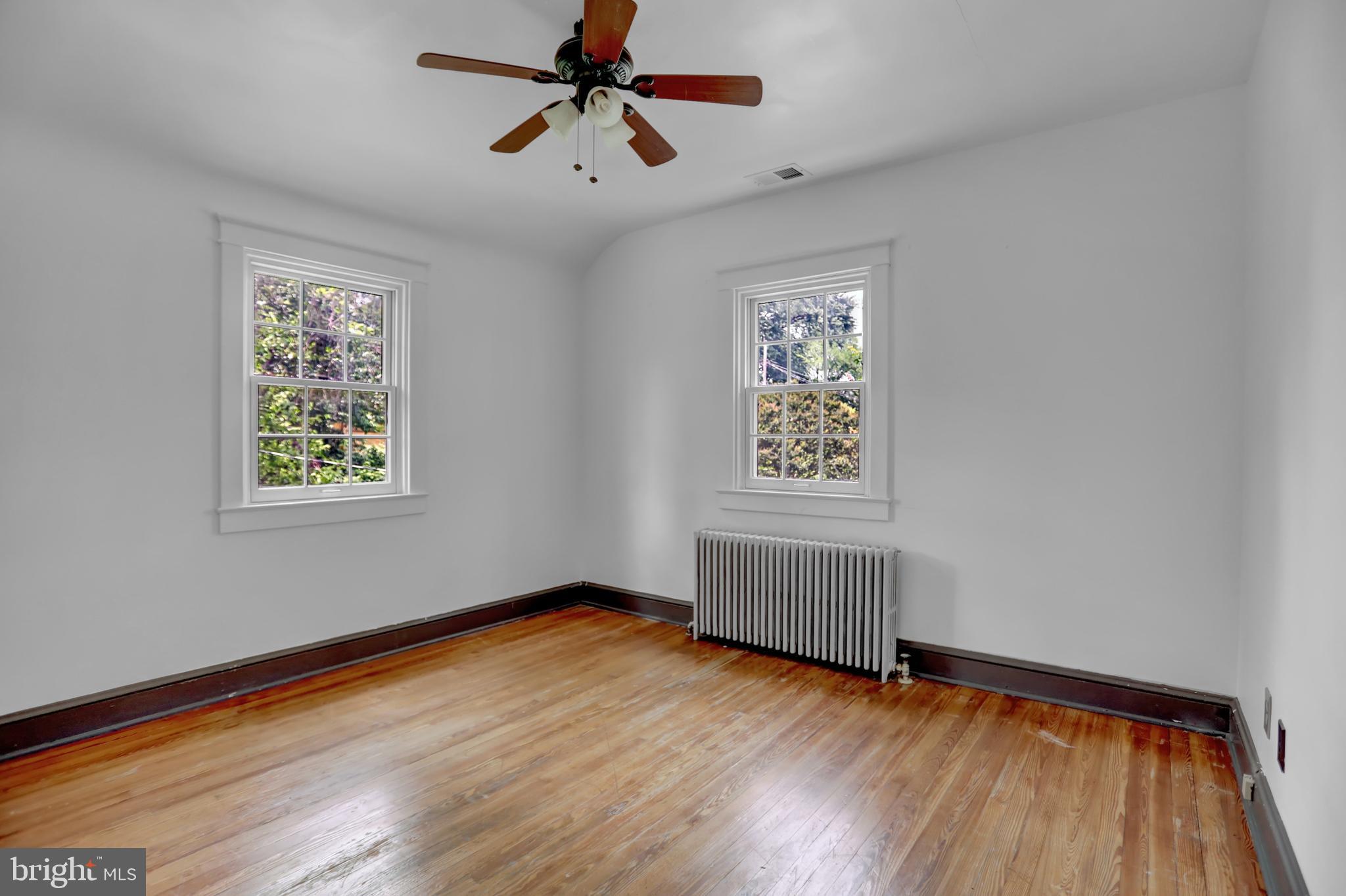 5544 Ashbourne Road Baltimore, MD 21227 - Photo 36 of 40 wooden floor in an empty room with a window