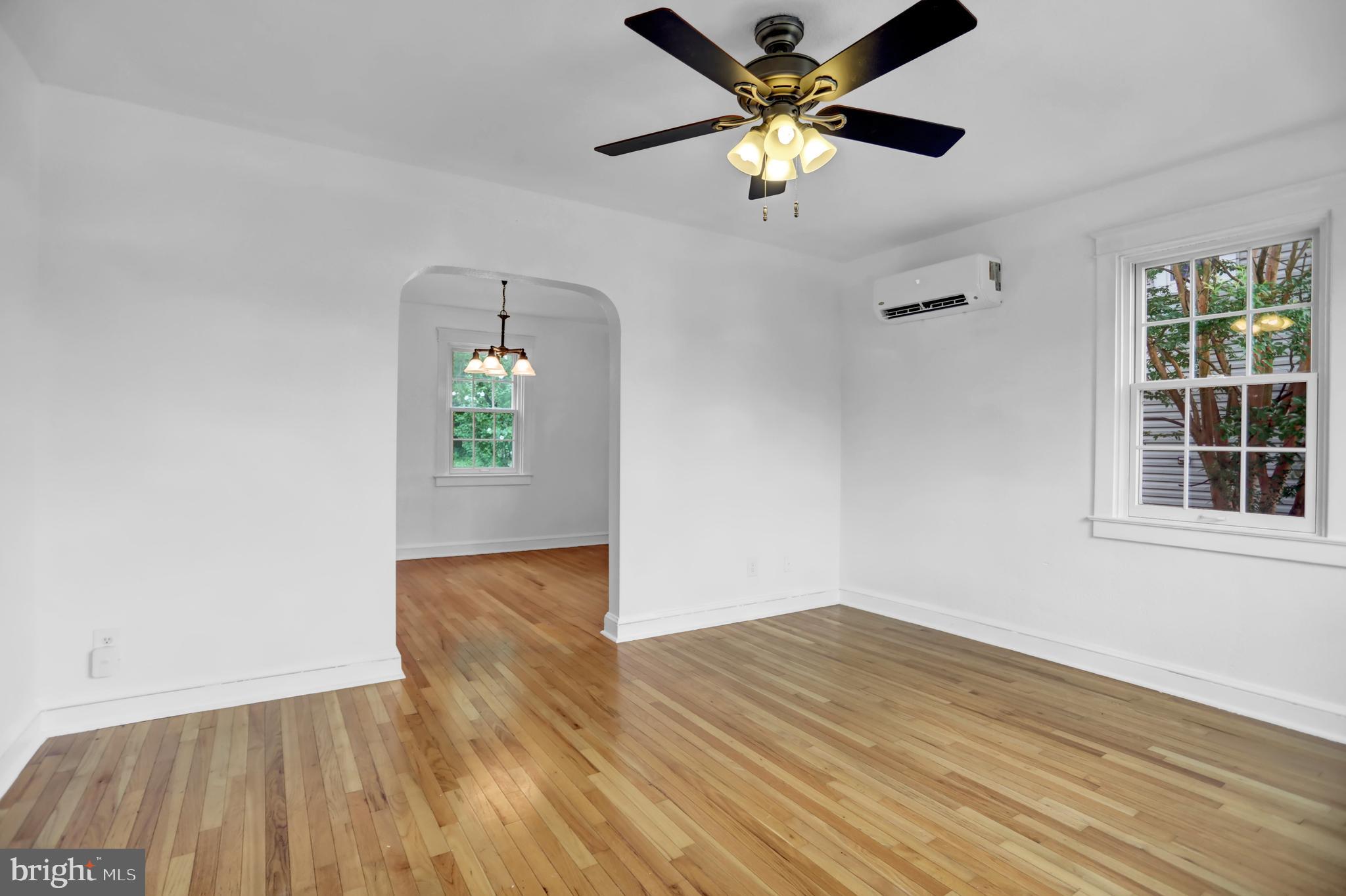 5544 Ashbourne Road Baltimore, MD 21227 - Photo 37 of 40 wooden floor in an empty room with a window