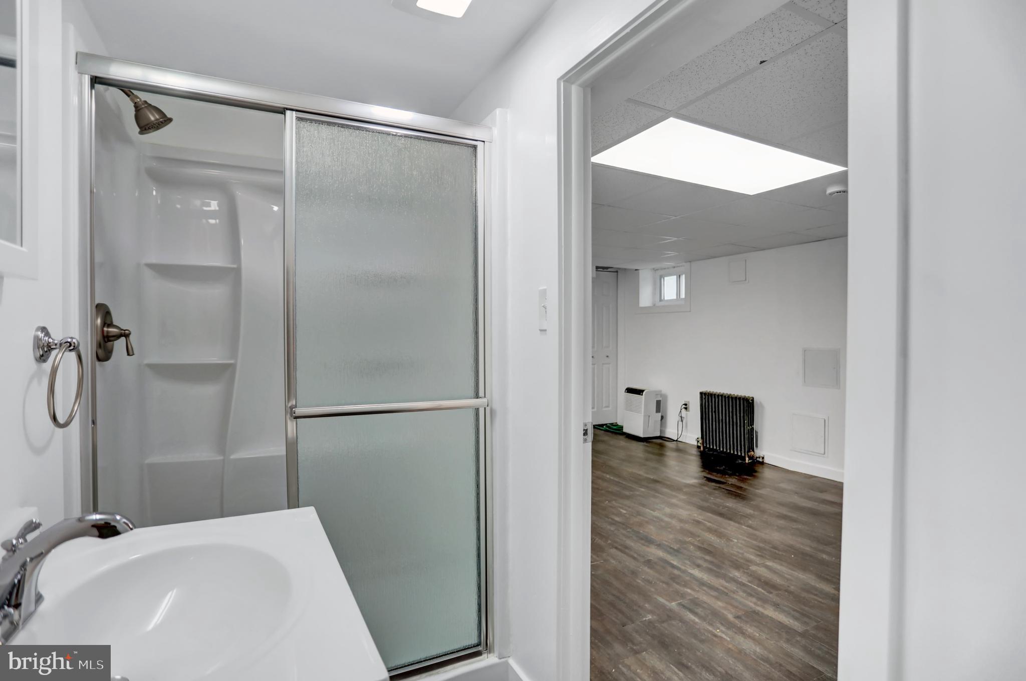 5544 Ashbourne Road Baltimore, MD 21227 - Photo 39 of 40 a bathroom with a sink and a shower