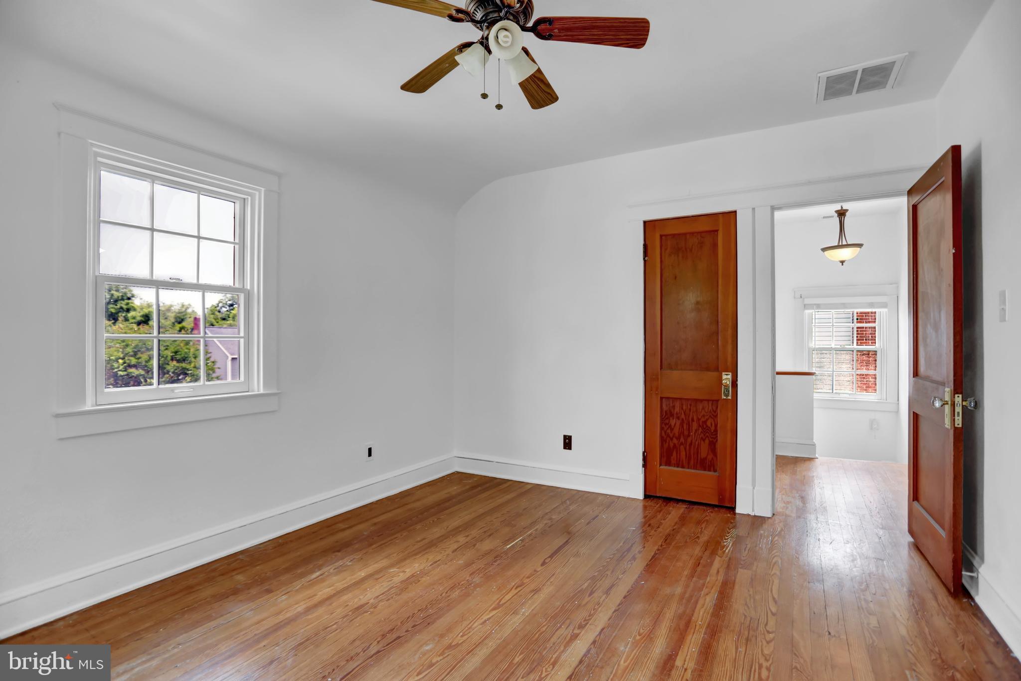 5544 Ashbourne Road Baltimore, MD 21227 - Photo 6 of 40 wooden floor in an empty room with a window