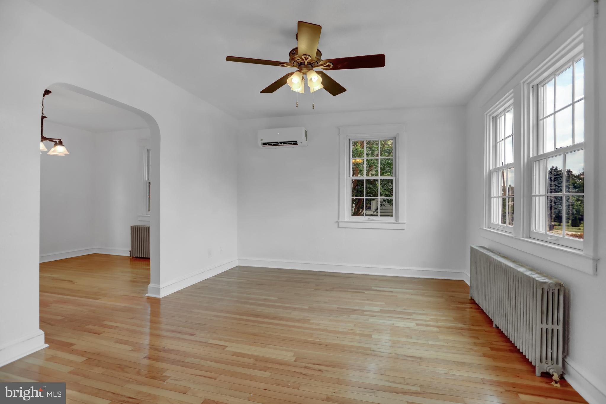 5544 Ashbourne Road Baltimore, MD 21227 - Photo 7 of 40 a view of an empty room with wooden floor and a window