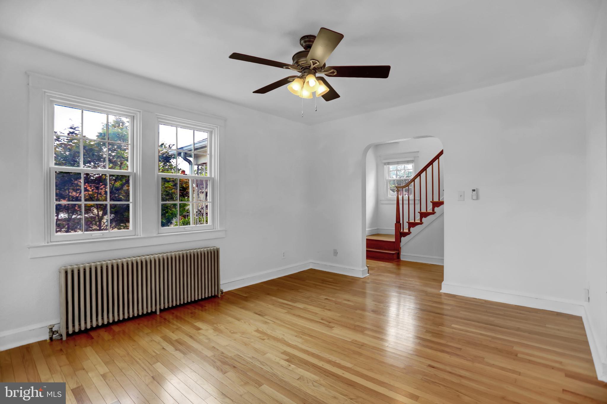 5544 Ashbourne Road Baltimore, MD 21227 - Photo 8 of 40 a view of an empty room with wooden floor and a window