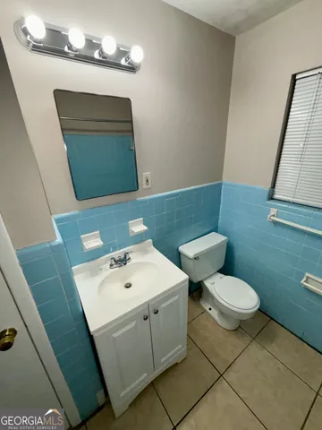 a bathroom with a sink a mirror and a toilet