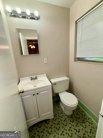 a bathroom with a sink toilet and mirror